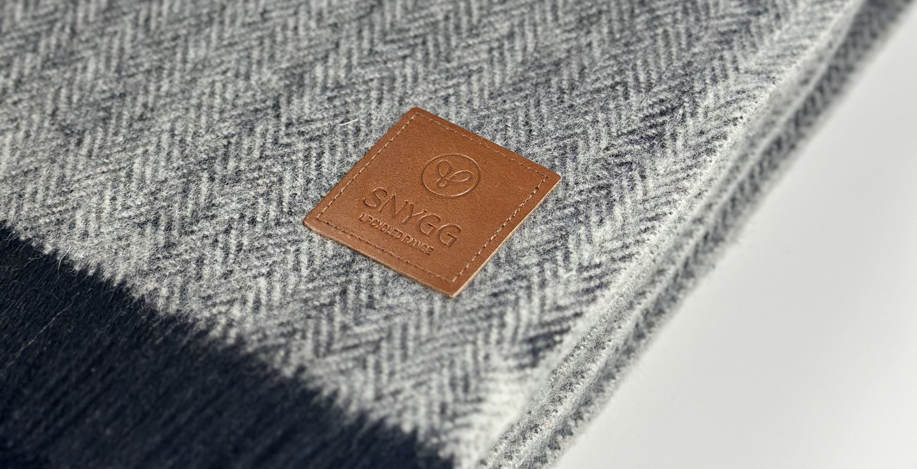 close up of SNYGG pet blanket in light grey