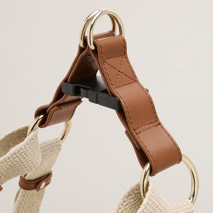 Brown and beige dog harness on a light gray background